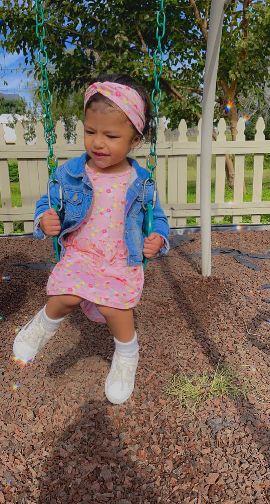 Geraldine is registered to the contest to win money with this photo: baby, baby_toddler_clothing, child, city, electric_blue, fashion_accessory, fence, fun, grass, headwear, magenta, outdoor_play_equipment, pattern, person, pink, plant, play, sleeve, smile, soil