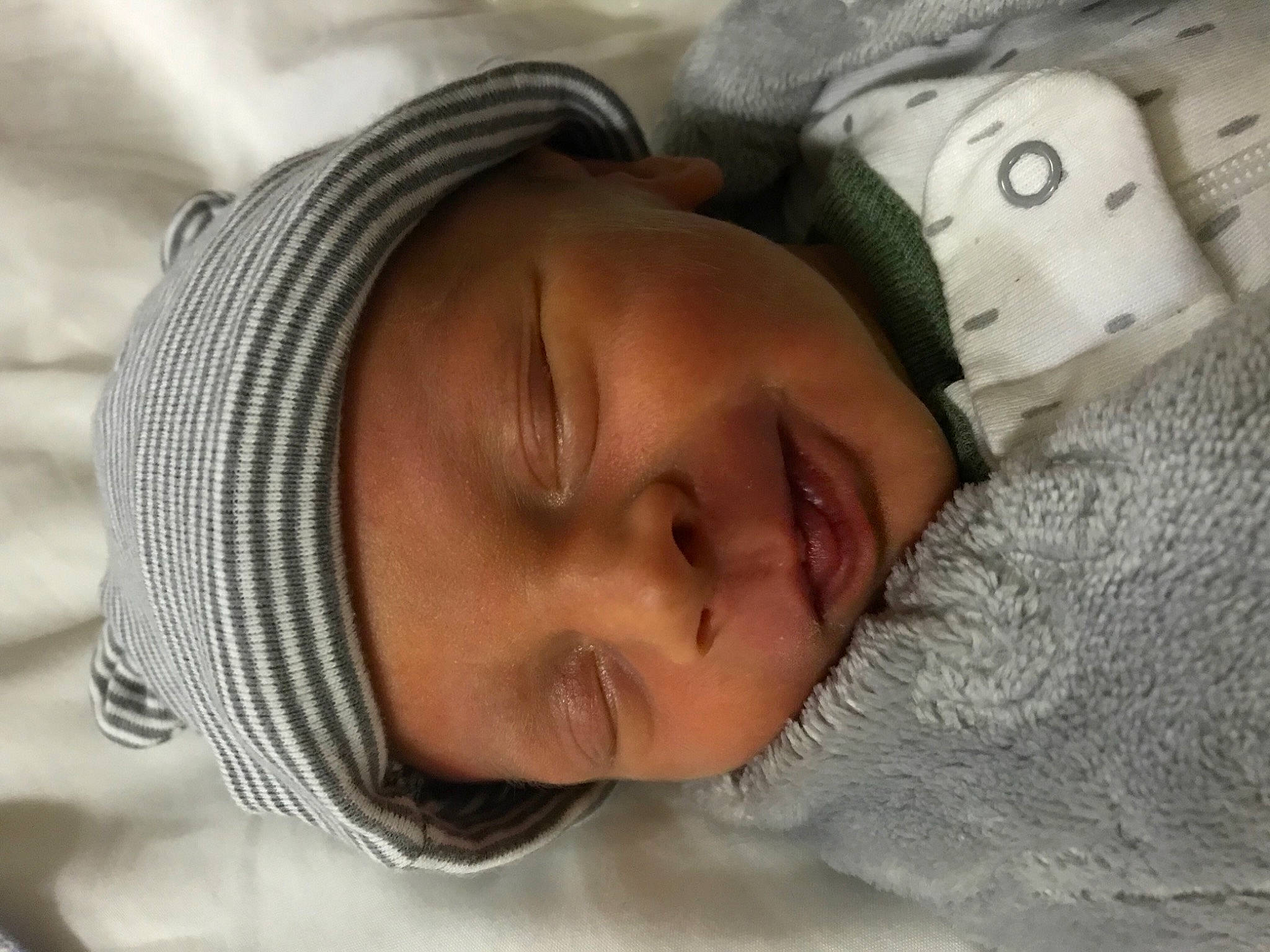 Knoxx is registered to the contest to win money with this photo: baby, cheek, comfort, eyebrow, eyelash, forehead, happy, headgear, headwear, linens, lip, mammal, mouth, nose, organ, person, skin, smile, textile, toddler