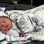 Lyzio participe au concours pour gagner de l'argent avec cette photo : newborn, baby, sleeping, blanket, onesie, soft_texture, baby_carrier, infant, peaceful, cozy, hand, face, clothing, indoor, resting, cute, young_child, comfort, portrait, calm
