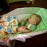baby, baby_rocker, blanket, carpet, child, cozy, cute, giraffe_toy, green, indoor, infant, nap_time, pacifier, patterned_blanket, peaceful, plush_toy, portrait, resting, sleeping, soft_lighting
