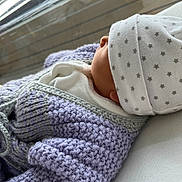 Aria participe au concours pour gagner de l'argent avec cette photo : newborn, baby, knitted_sweater, purple, hat, stars, sleeping, window, natural_light, soft_texture, closeup, infant, cozy, warm_clothing, peaceful, side_profile, person, child, cuteness, indoors