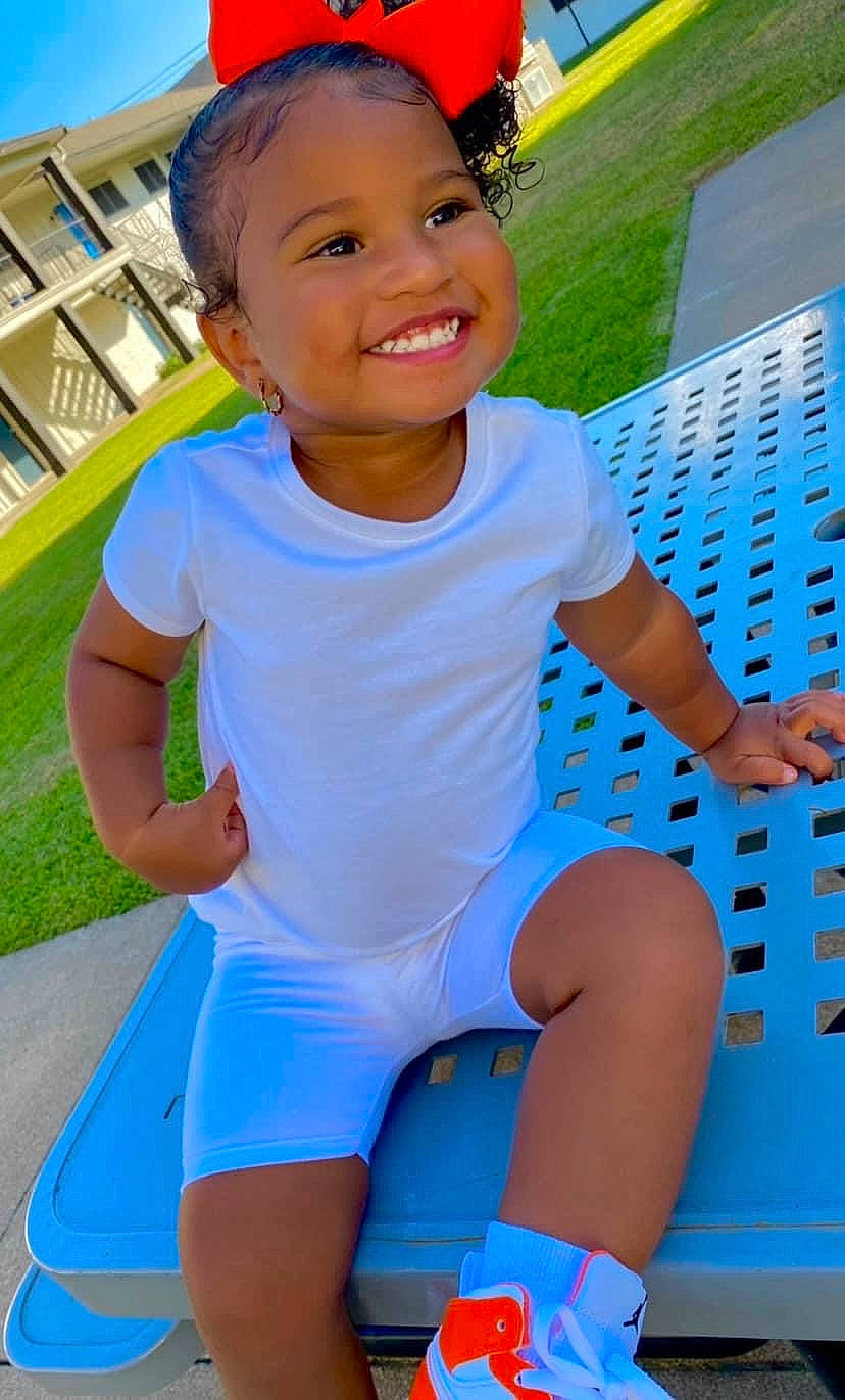 Averi joined the competition — help win amazing prizes! azure, baby_toddler_clothing, blue, cap, facial_expression, finger, fun, green, happy, joy, leisure, person, photograph, plant, red, skin, sleeve, smile, standing, thigh