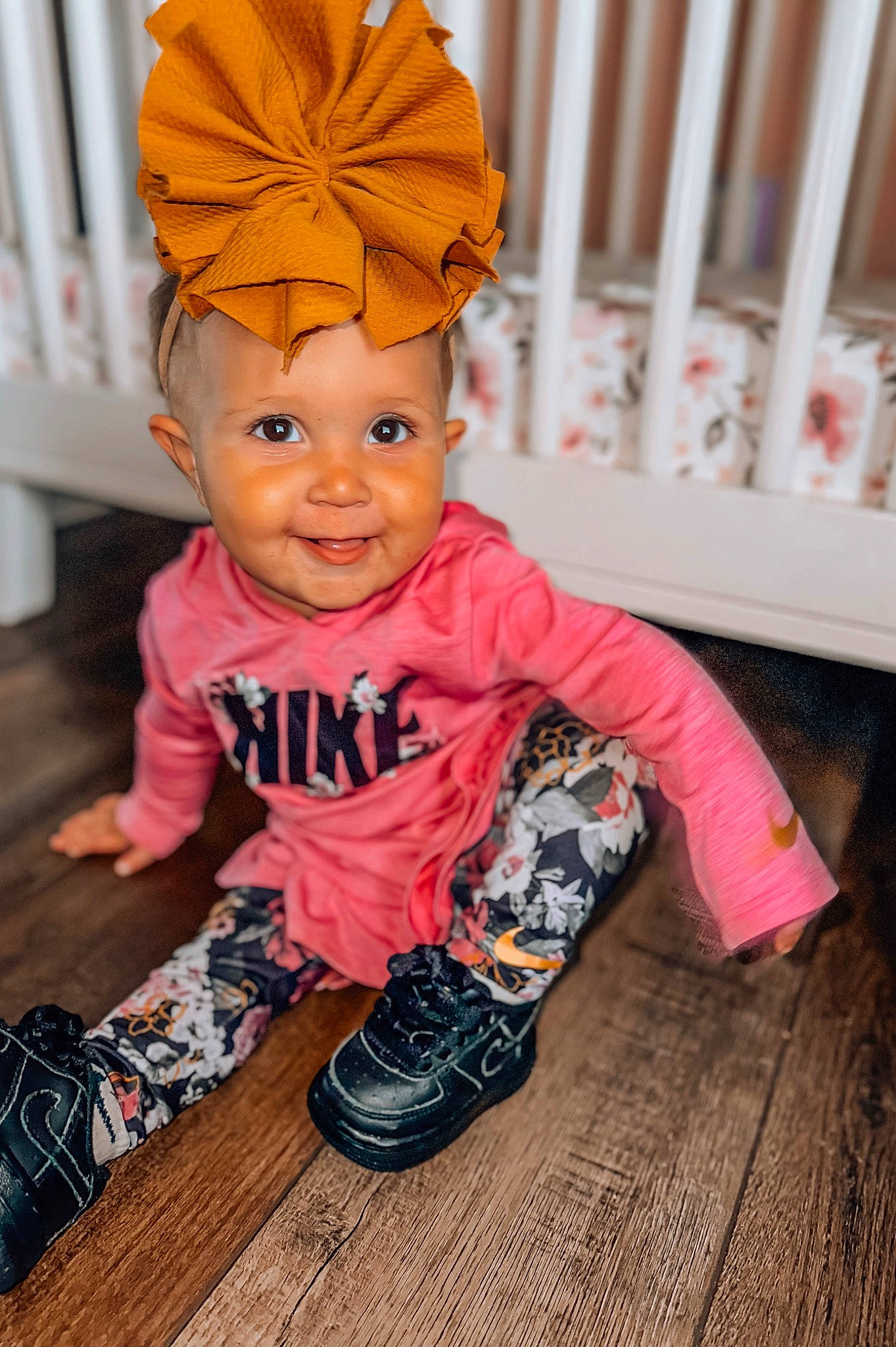 Adelaine is registered to the contest to win money with this photo: baby, baby_toddler_clothing, cap, child, fashion_accessory, fence, flooring, fun, happy, hardwood, headgear, headwear, joy, magenta, orange, person, personal_protective_equipment, pink, sleeve, smile