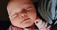 Lainey joined the competition — help win amazing prizes! baby, sleeping, infant, pink_onesie, hand, face, peaceful, soft_light, closeup, portrait, newborn, cozy, child, resting, cute, indoors, human, skin, head, peace