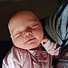 baby, sleeping, infant, pink_onesie, hand, face, peaceful, soft_light, closeup, portrait, newborn, cozy, child, resting, cute, indoors, human, skin, head, peace