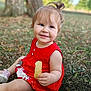 Marina participe au concours pour gagner de l'argent avec cette photo : toddler, child, red_dress, bread, smile, outdoor, grass, nature, happy, cute, sitting, young_child, daylight, portrait, face, person, fashion, playful, summer, innocence