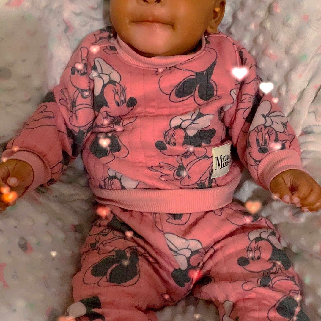 Jermani Brown is registered to the contest to win money with this photo: baby, blanket, child, childrens_clothing, comfortable, cozy, cute, fuzzy_slippers, happy, heart_lights, indoor, infant, minnie_mouse, pajamas, person, pink_clothing, portrait, smiling, soft_texture, warm