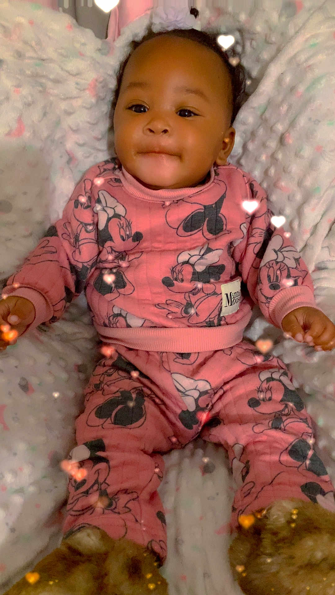 Jermani Brown is registered to the contest to win money with this photo: baby, child, pink_clothing, minnie_mouse, pajamas, fuzzy_slippers, blanket, heart_lights, cute, indoor, portrait, happy, smiling, soft_texture, infant, cozy, childrens_clothing, warm, comfortable, person