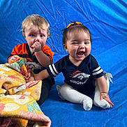 Ysabella is registered to the contest to win money with this photo: baby, ball, blanket, bodypart, clothing, couch, face, finger, football, furniture, hand, happy, head, laughing, pants, person, photography, portrait, quilt, t_shirt