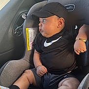 Dylan Suárez is registered to the contest to win money with this photo: baby, car_seat, child, black_clothing, cap, bracelet, footwear, indoor, infant, looking_away, person, seat, sitting, side_view, sporty, window, young_child, cute, casual, relaxed