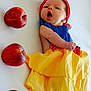 Hope participe au concours pour gagner de l'argent avec cette photo : baby, infant, child, apples, yellow_skirt, red_headband, blue_top, lying_down, white_background, fruit, cute, adorable, costume, dress, newborn, small_feet, face, expression, sleepy, colorful_clothing