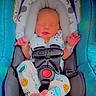 newborn, baby, sleeping, car_seat, pajamas, infant, child, blue, safety_harness, headrest, cute, peaceful, indoors, clothing, small, foot, hand, resting, baby_girl_or_boy, soft