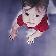 Amari joined the competition — help win amazing prizes! child, baby, infant, toddler, red_clothing, onesie, face, eyes, looking_up, hands, palms, hair, portrait, closeup, top_view, curious_expression, soft_focus, indoor, floor, candid