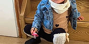 Eva participe au concours pour gagner de l'argent avec cette photo : toddler, child, denim_jacket, pigtails, pacifier, stairs, wooden, indoor, flooring, leg_warmers, boots, smiling, cute, playful, scarf, fashion, young, person, portrait, casual