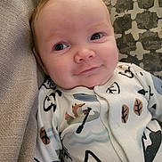 Cairo is registered to the contest to win money with this photo: baby, infant, face, smile, onesie, clothing, pattern, fox, mountain, leaf, blanket, texture, cozy, cute, child, person, indoors, portrait, closeup, happy