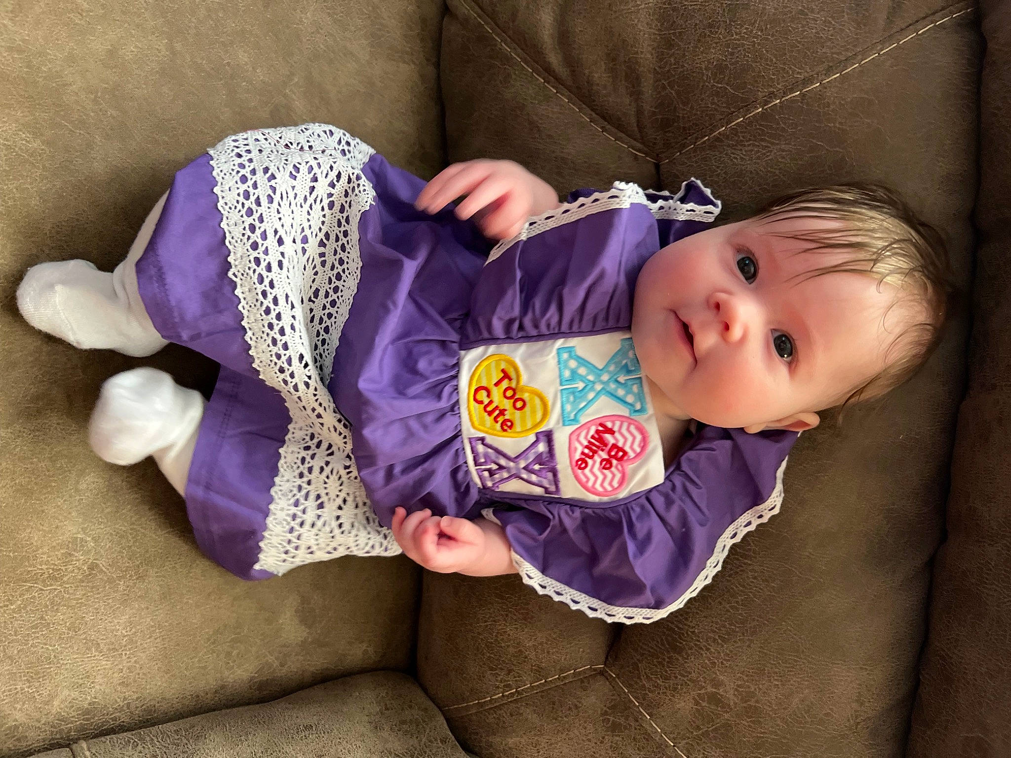 Oakley is registered to the contest to win money with this photo: baby, baby_products, baby_toddler_clothing, cheek, child, comfort, eye, head, headgear, human_body, person, product, purple, sitting, skin, sleeve, textile, toddler, tree, violet