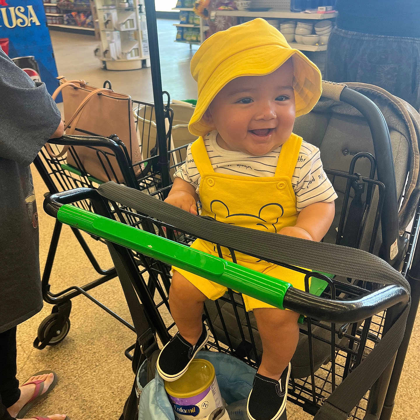 Anthony Gomez is registered to the contest to win money with this photo: baby, child, shopping_cart, yellow_hat, yellow_outfit, smile, grocery_store, person, footwear, can, bag, shopping, clothing, happy, indoor, retail, store_shelves, people, casual, infant