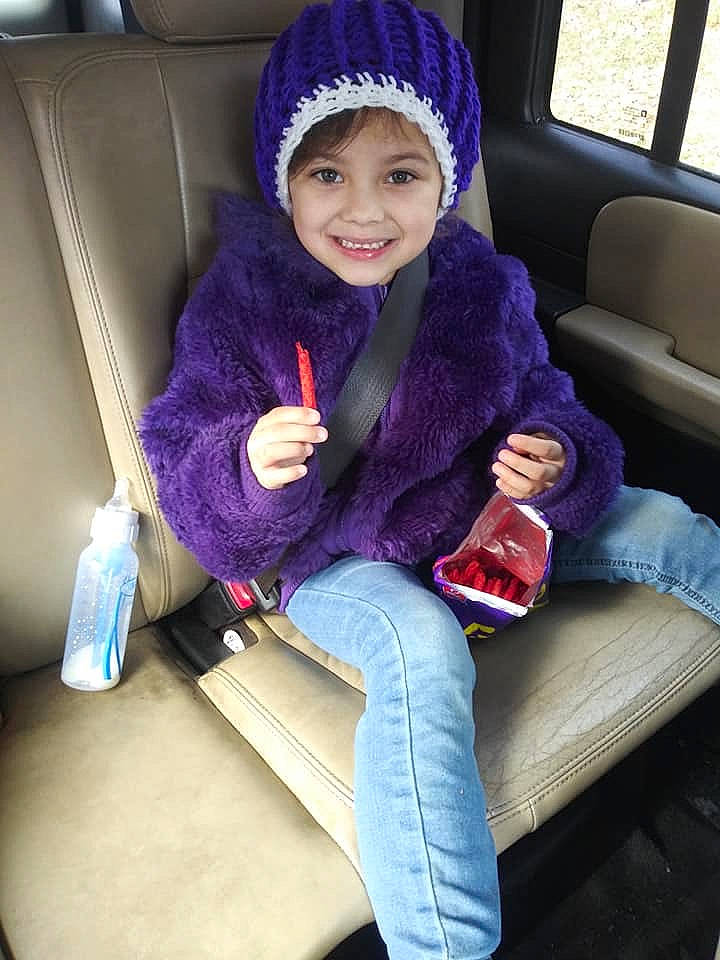 Nariah is registered to the contest to win money with this photo: beanie, cap, car_seat, child, ear, fun, fur, headgear, headwear, joy, knit_cap, knitting, magenta, person, purple, sitting, toddler, violet, winter, wool