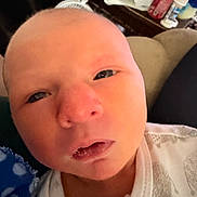 Colby joined the competition — help win amazing prizes! newborn, baby, face, infant, clothing, white, elephant_print, indoors, closeup, portrait, curious_expression, human, skin, head, person, soft_lighting, blanket, couch, baby_garment, resting