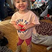 Isabella joined the competition — help win amazing prizes! toddler, child, smile, boots, pink_pants, tshirt, dog, indoor, wood_floor, blanket, person, happy, home, pet, cozy, casual_clothing, flooring, animal, furniture, toy