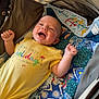 Rayne joined the competition — help win amazing prizes! baby, smiling, yellow_onesie, stroller, quilt, patchwork, happy, child, infant, baby_clothes, fabric, colorful, cute, outdoor, sunlight, portrait, small_child, cheerful, relaxed, lying_down