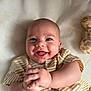 Rayne is registered to the contest to win money with this photo: baby, smile, clapping_hands, striped_clothing, plush_toy, giraffe_toy, lying_down, happy, infant, face, cute, skin, cheeks, hands, eyes, mouth, blanket, soft_texture, indoors, portrait