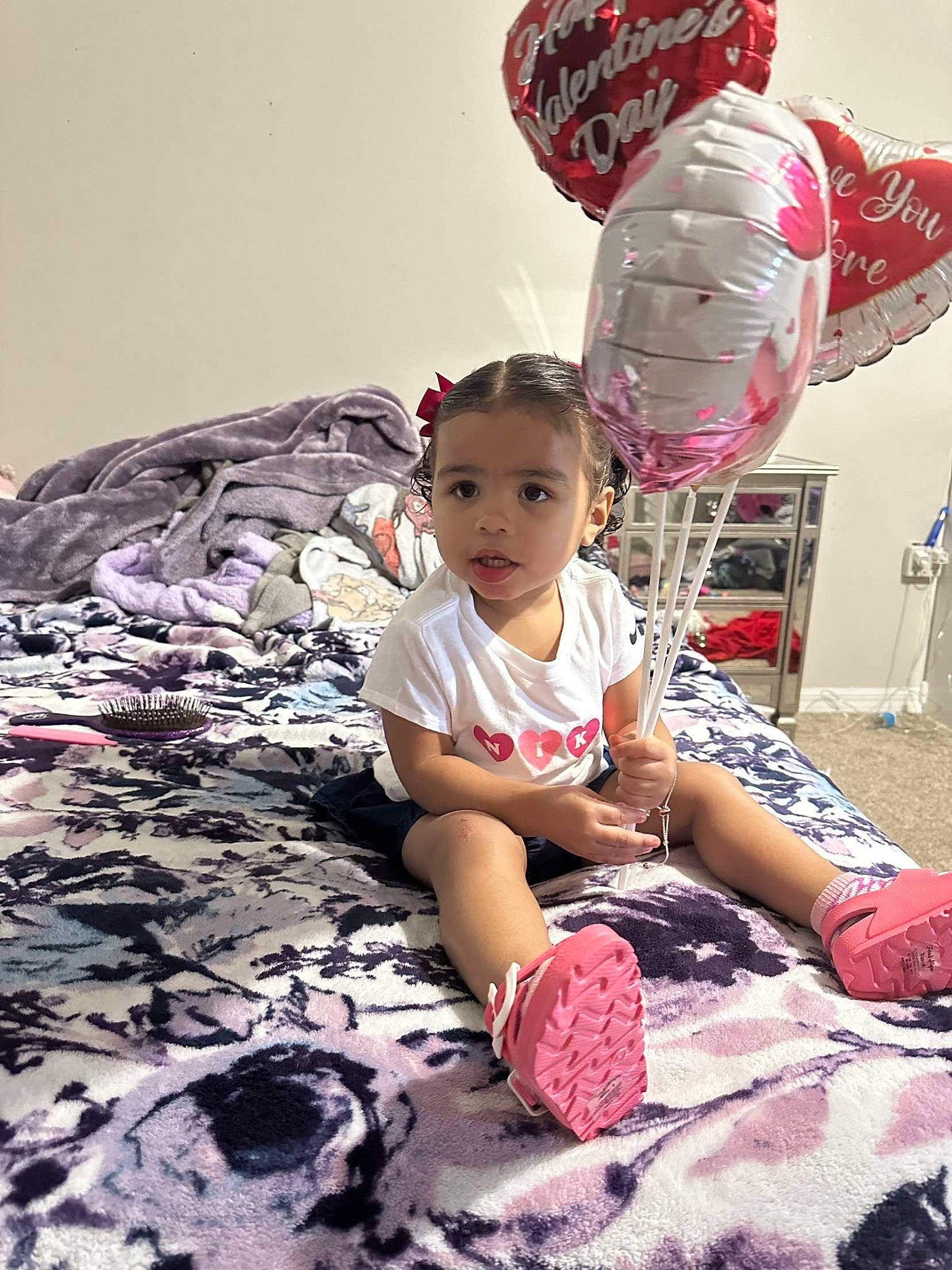 Kaniya joined the competition — help win amazing prizes! baby, baby_toddler_clothing, carmine, child, flooring, fun, happy, human_leg, leisure, linens, magenta, pattern, person, pink, purple, room, sand, shorts, sitting, t_shirt