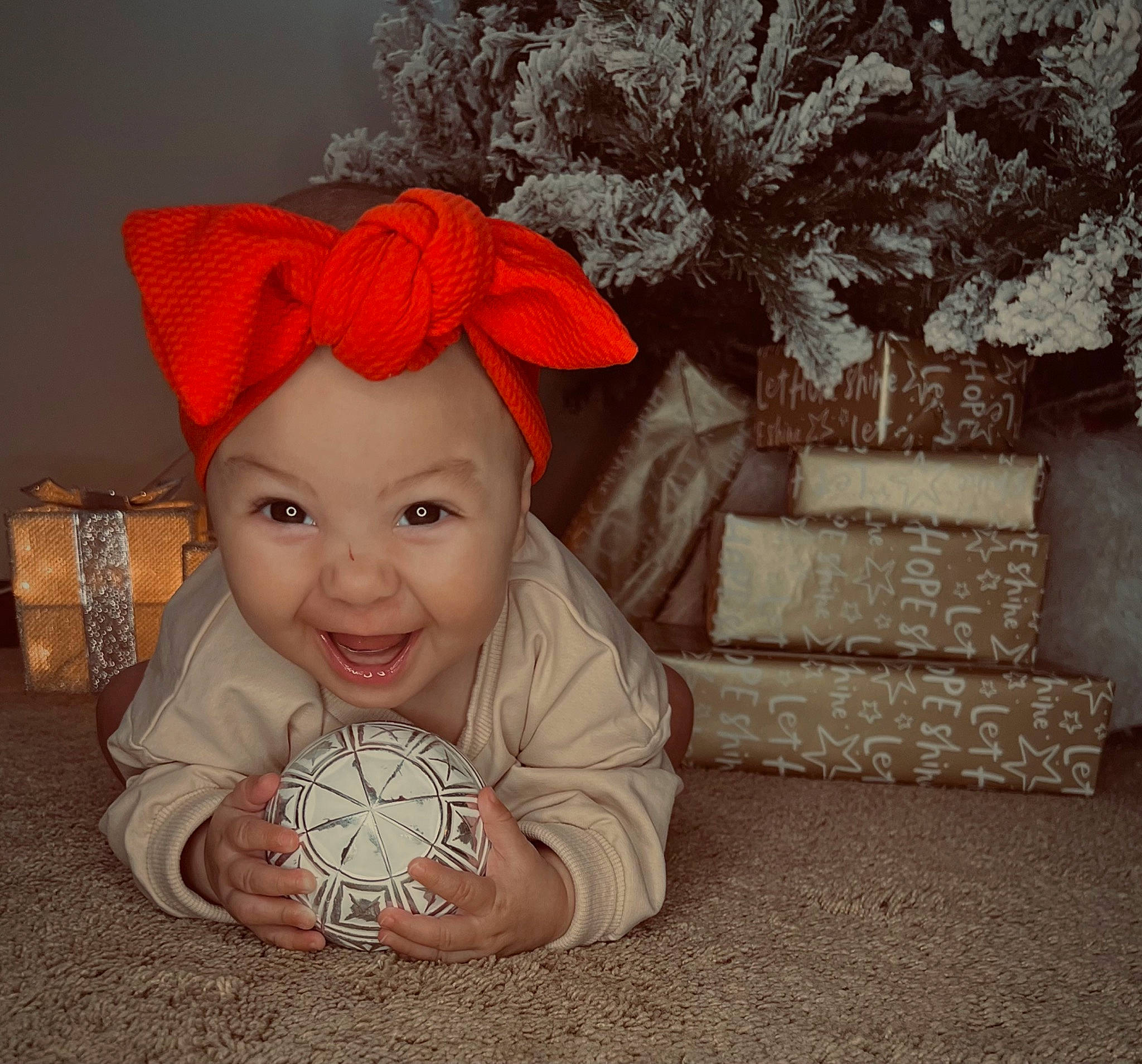 Aaliyah joined the competition — help win amazing prizes! baby, baby_laughing, baby_toddler_clothing, carmine, child, christmas, christmas_eve, costume_hat, fashion_accessory, fictional_character, flooring, happy, hat, head, headwear, holiday, joy, person, room, sitting