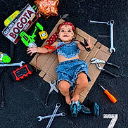 Anny Celeste joined the competition — help win amazing prizes! baby, denim_clothing, cardboard, tools, wrench, pliers, screwdriver, toy_drill, balloon, face_paint, bandana, asphalt, happy, child, playing, smiling, outdoor, sign, colorful, portrait