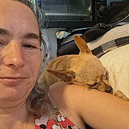 Lucky Ducky is registered to the contest to win money with this photo: arm, blanket, casual, closeup, clothing, cushion, dog, face, furniture, hair, home, indoor, pattern, person, pet, relaxed, resting, sleeping, smiling, toaster_oven