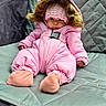Lilia is registered to the contest to win money with this photo: baby, pink_snowsuit, knitted_hat, cushioned_chair, outdoor, cozy, child, winter_clothing, infant, cute, soft_texture, warm, seated, portrait, fur_trim, footwear, expression, small_hands, fabric, relaxation