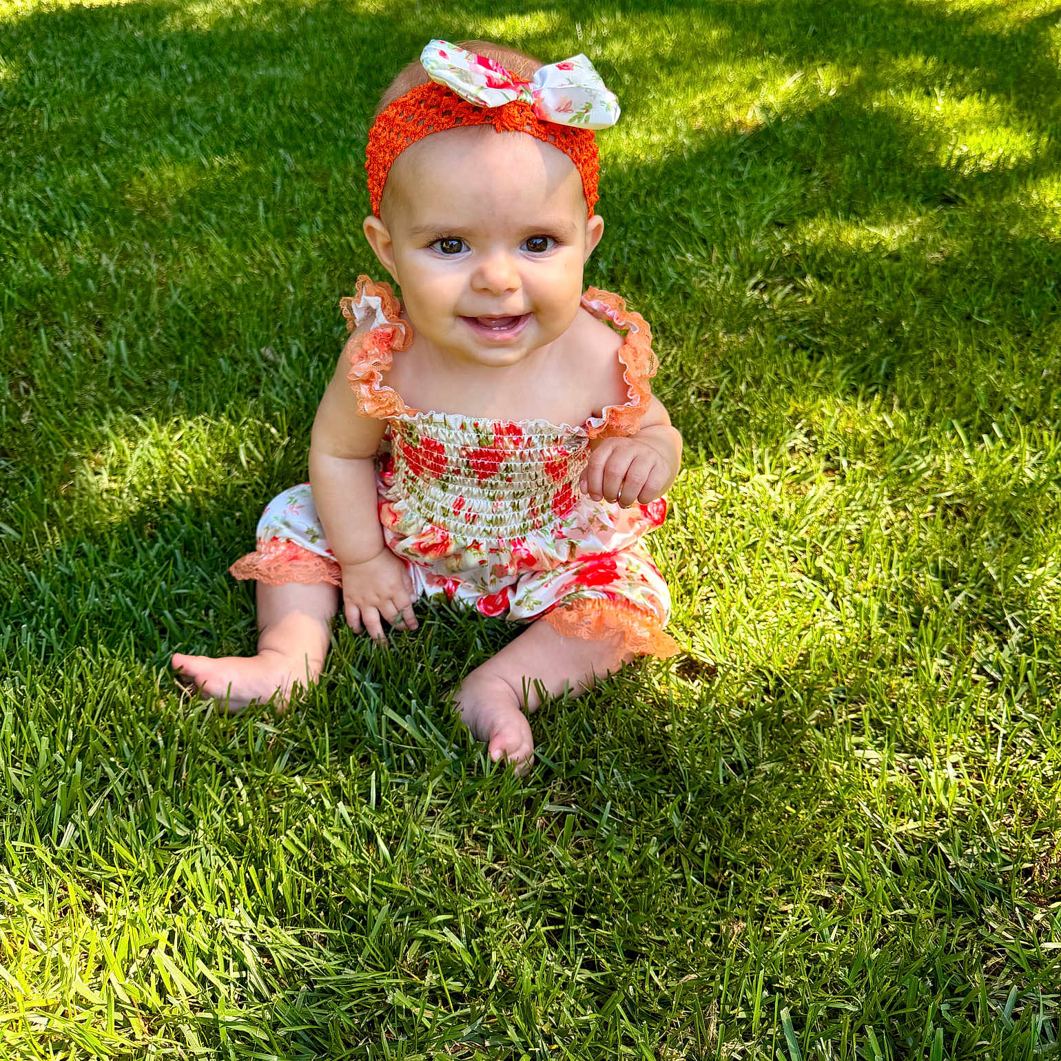 Lilia joined the competition — help win amazing prizes! baby, child, grass, outdoor, smile, headband, flower_pattern, sitting, sunlight, greenery, nature, cute, portrait, summer, happy, infant, baby_clothes, headwear, skin, barefoot