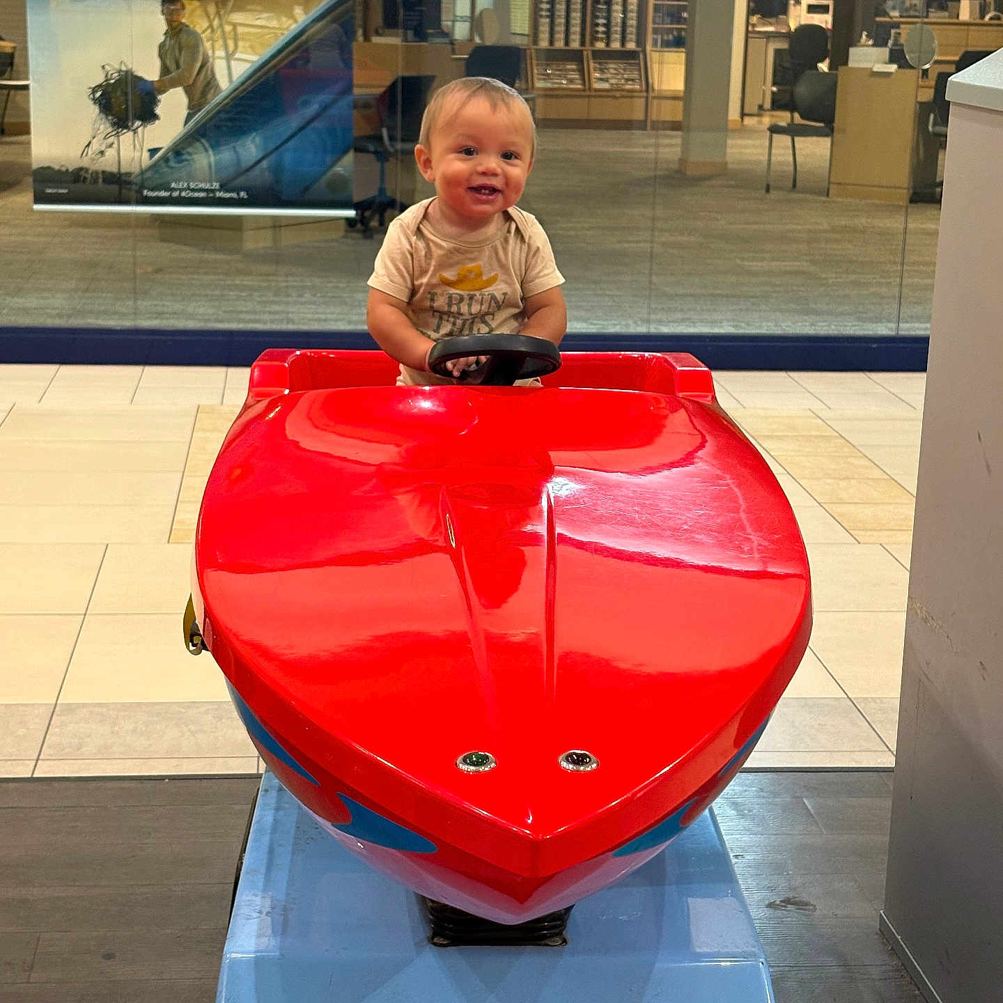 Aizen joined the competition — help win amazing prizes! boat, casual_clothing, chair, child, floor, glass_wall, happy, indoor, light, office, person, play, red, reflection, ride, smile, steering_wheel, store, toddler, toy