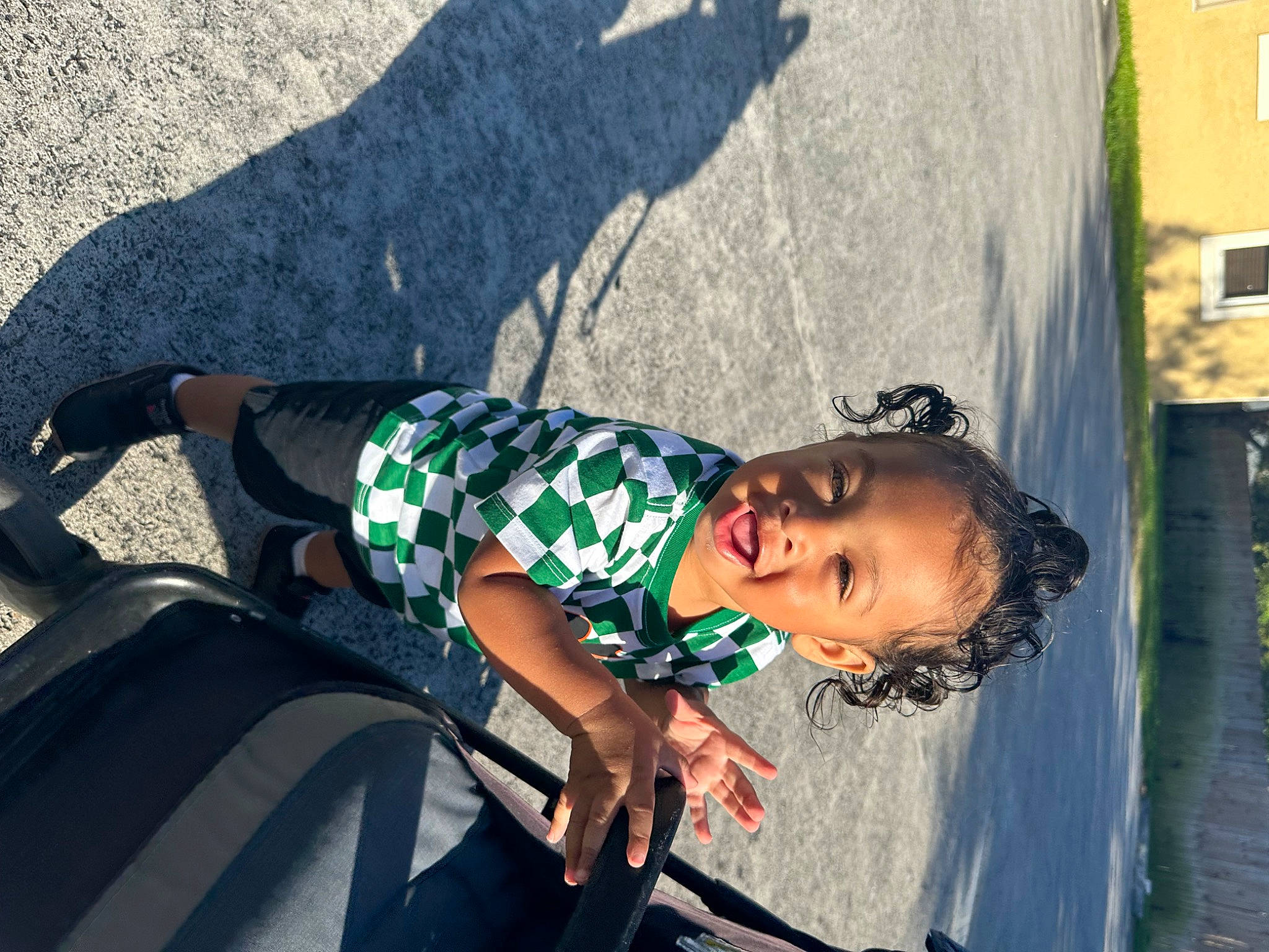 Jeremiah joined the competition — help win amazing prizes! adventure, black_hair, child, eyewear, fun, grass, happy, human_leg, leisure, person, recreation, road, sandal, sitting, smile, street, sunglasses, toddler, tree, vacation