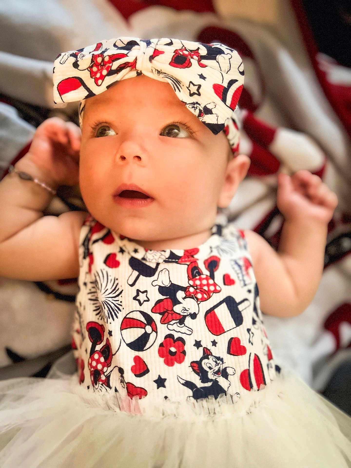 Shado is registered to the contest to win money with this photo: baby, infant, child, headband, mickey_mouse, minnie_mouse, dress, tutu, cute, portrait, looking_up, indoor, clothing, colorful, soft_focus, closeup, young_child, adorable, smiling, happy