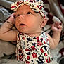 baby, infant, headband, clothing, patterned_clothing, cartoon_characters, red, white, blue, tutu, cute, portrait, child, smiling, face, hand, soft_fabric, blanket, indoors, young_child