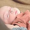Isaac is registered to the contest to win money with this photo: baby, sleeping, infant, portrait, close_up, face, indoors, couch, blanket, pink_clothing, knitwear, cozy, peaceful, resting, closed_eyes, soft_lighting, warm_tones, head, newborn, family_photo