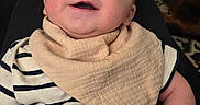 Isaac joined the competition — help win amazing prizes! baby, infant, child, smiling, portrait, indoor, seated, striped_shirt, scarf, blanket, blue_pants, home, door, rug, furniture, close_up, happy, family, casual, photograph