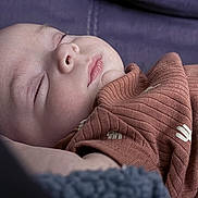 Isaac joined the competition — help win amazing prizes! newborn, baby, sleeping, portrait, close_up, face, indoors, blanket, clothing, cozy, peaceful, resting, infant, skin, eyes_closed, nose, lips, soft_lighting, textile, bed