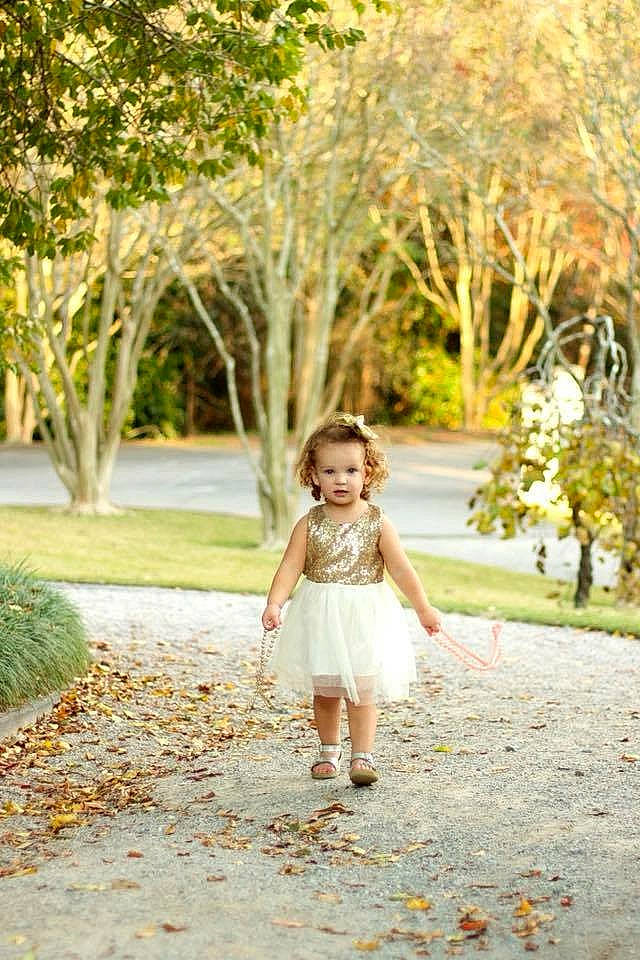 Kendall is registered to the contest to win money with this photo: branch, child, child_model, dress, footwear, grass, leaf, pattern, people_in_nature, person, photograph, photography, plant, portrait_photography, shoe, shoulder, toddler, tree, waist, walking