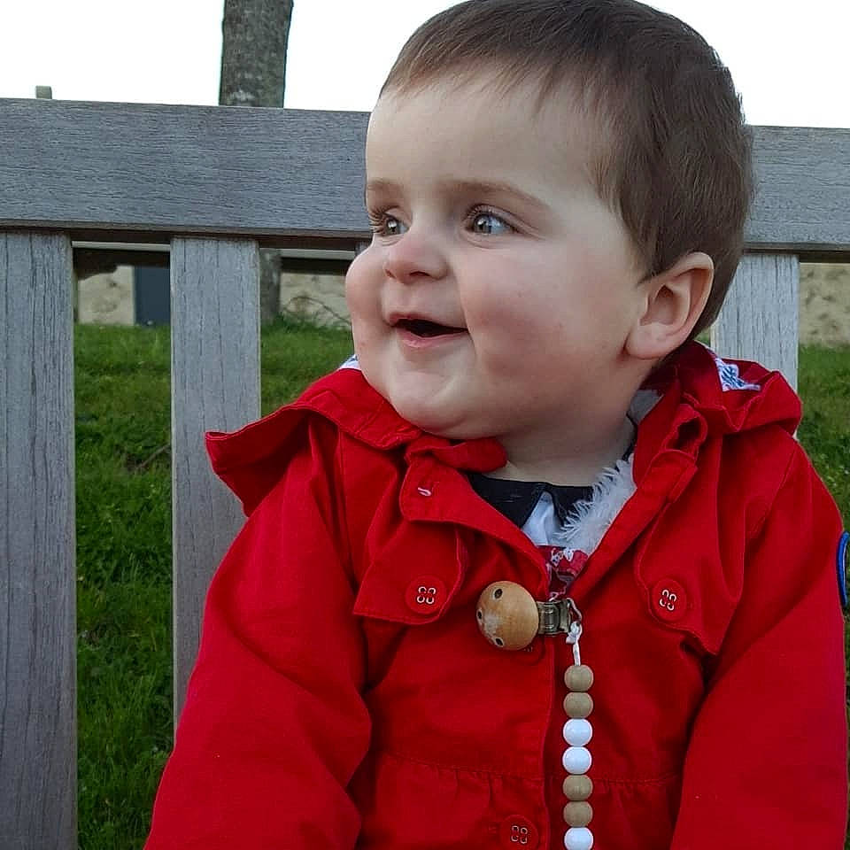 Neela participe au concours pour gagner de l'argent avec cette photo : baby, cheek, child, chin, face, hoodie, jacket, outerwear, person, red, skin, sleeve, smile, toddler
