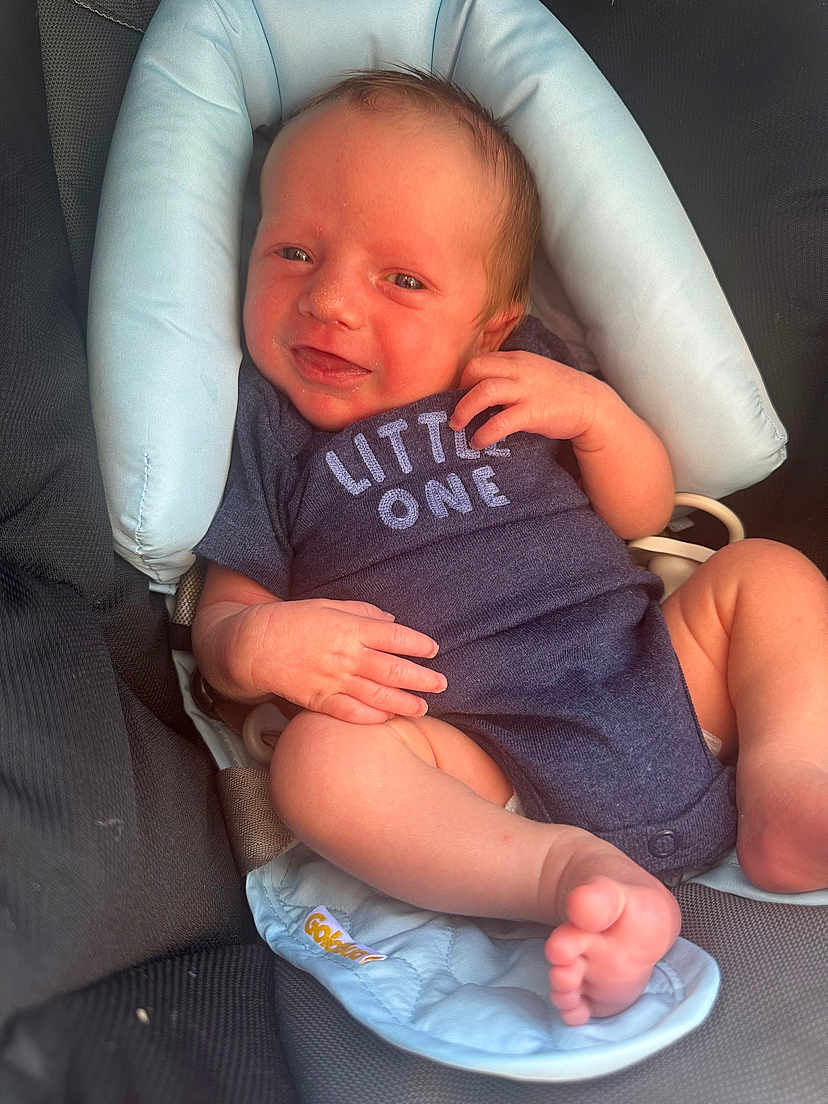 Soryn joined the competition — help win amazing prizes! baby, newborn, infant, onesie, car_seat, smiling, child, cute, cushion, clothing, skin, hand, foot, seat, comfort, resting, indoors, portrait, young, happy