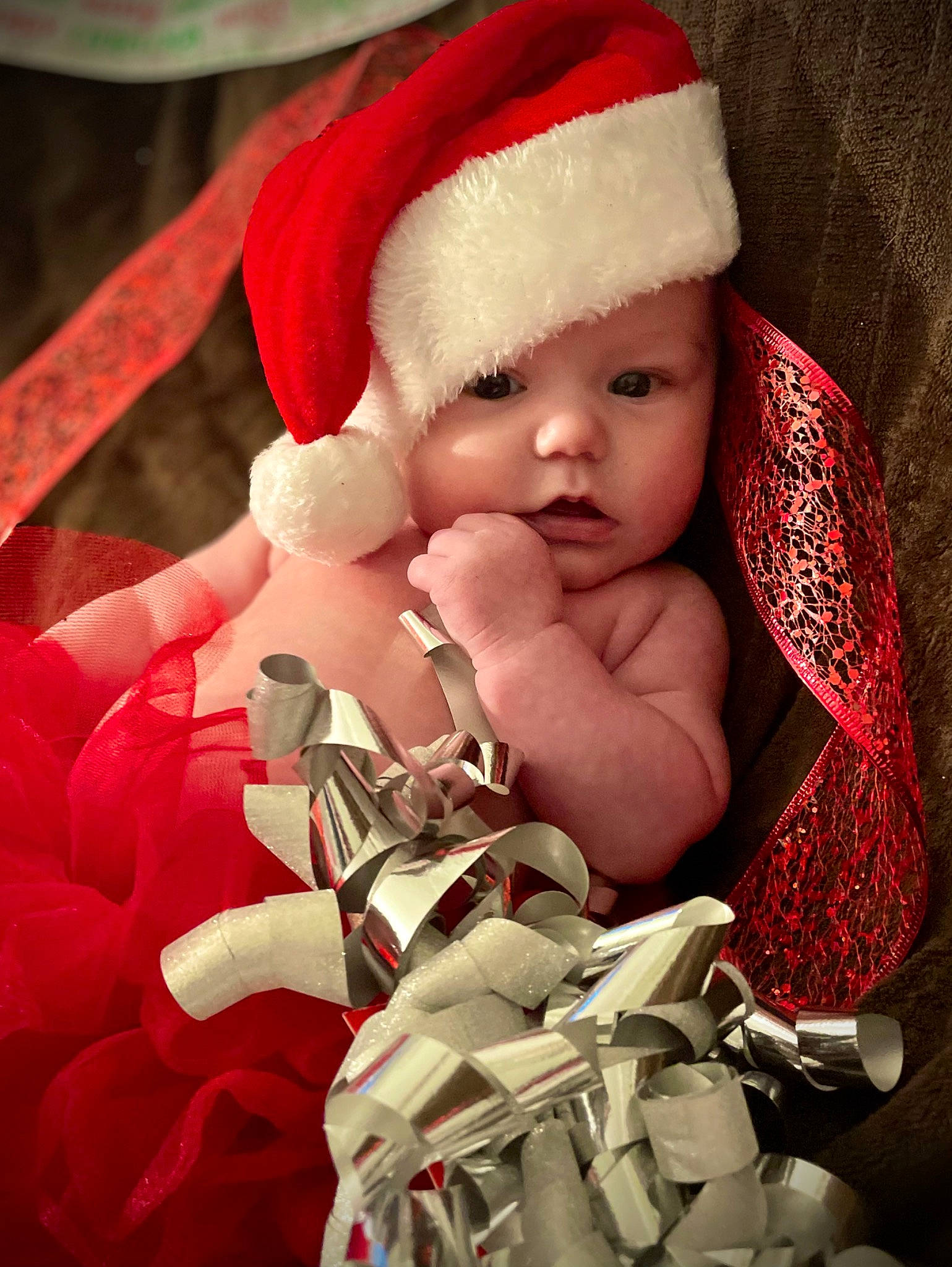 Harper is registered to the contest to win money with this photo: baby, baby_sleeping, baby_toddler_clothing, cap, child, christmas, christmas_decoration, christmas_eve, christmas_ornament, costume_hat, event, fictional_character, gesture, headwear, nail, ornament, person, red, santa_claus, stuffed_toy