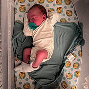 Haven is registered to the contest to win money with this photo: baby, newborn, sleeping, crib, pacifier, blanket, onesie, sock, bedding, winnie_the_pooh, polka_dots, infant, face, child, toddler, soft_lighting, indoors, cozy, sleep, rest