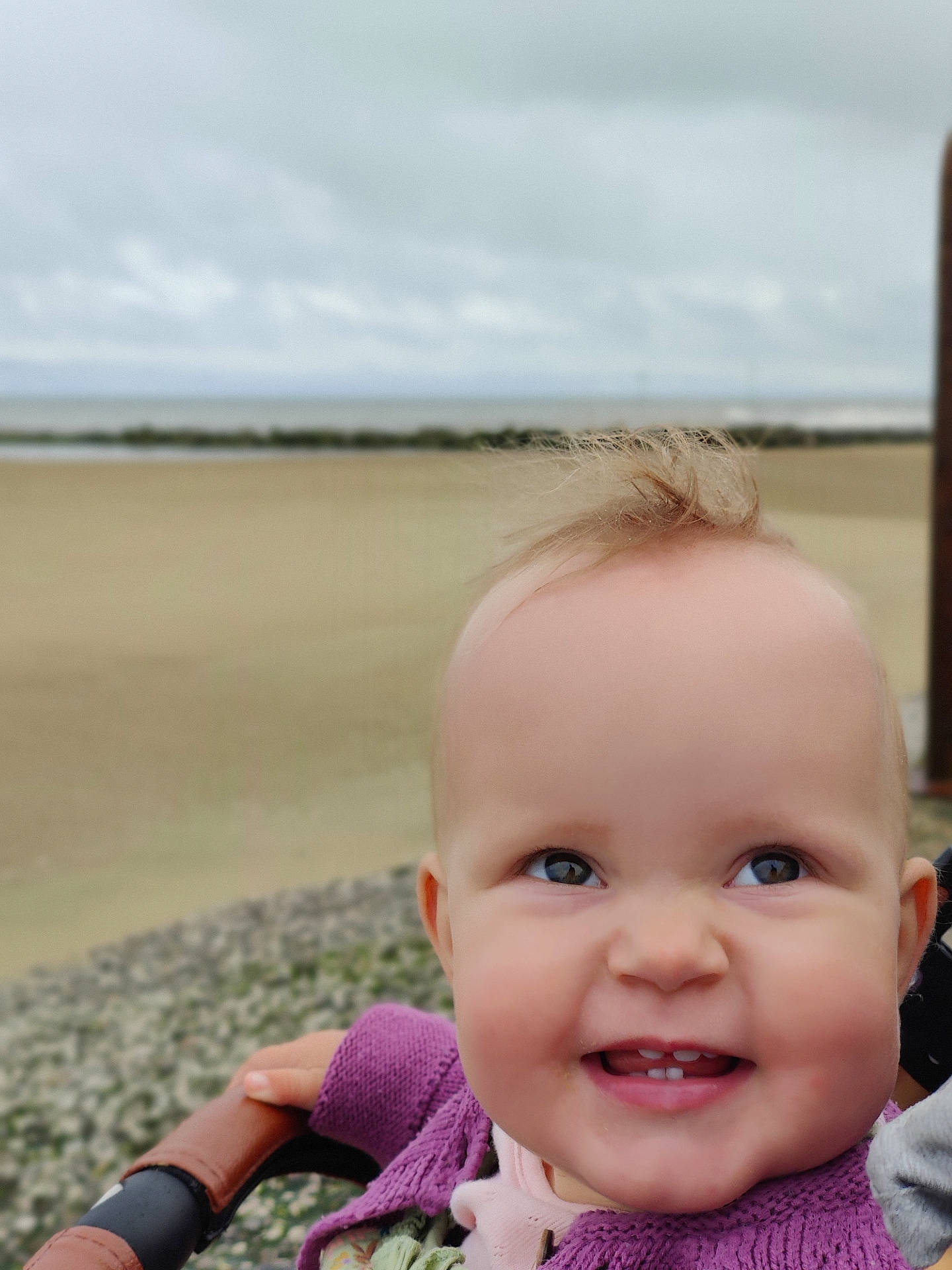 Aurora joined the competition — help win amazing prizes! accessories, baby, babylaughing, beach, blonde, bodypart, clothing, coast, coat, ear, face, finger, fleece, frown, hair, hand, happy, head, hood, hoodie