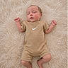 Legend joined the competition — help win amazing prizes! baby, sleeping, infant, onesie, nike, logo, soft_rug, cream_color, cozy, peaceful, newborn, lying_down, hands_up, closed_eyes, indoor, portrait, child, cute, skin, foot