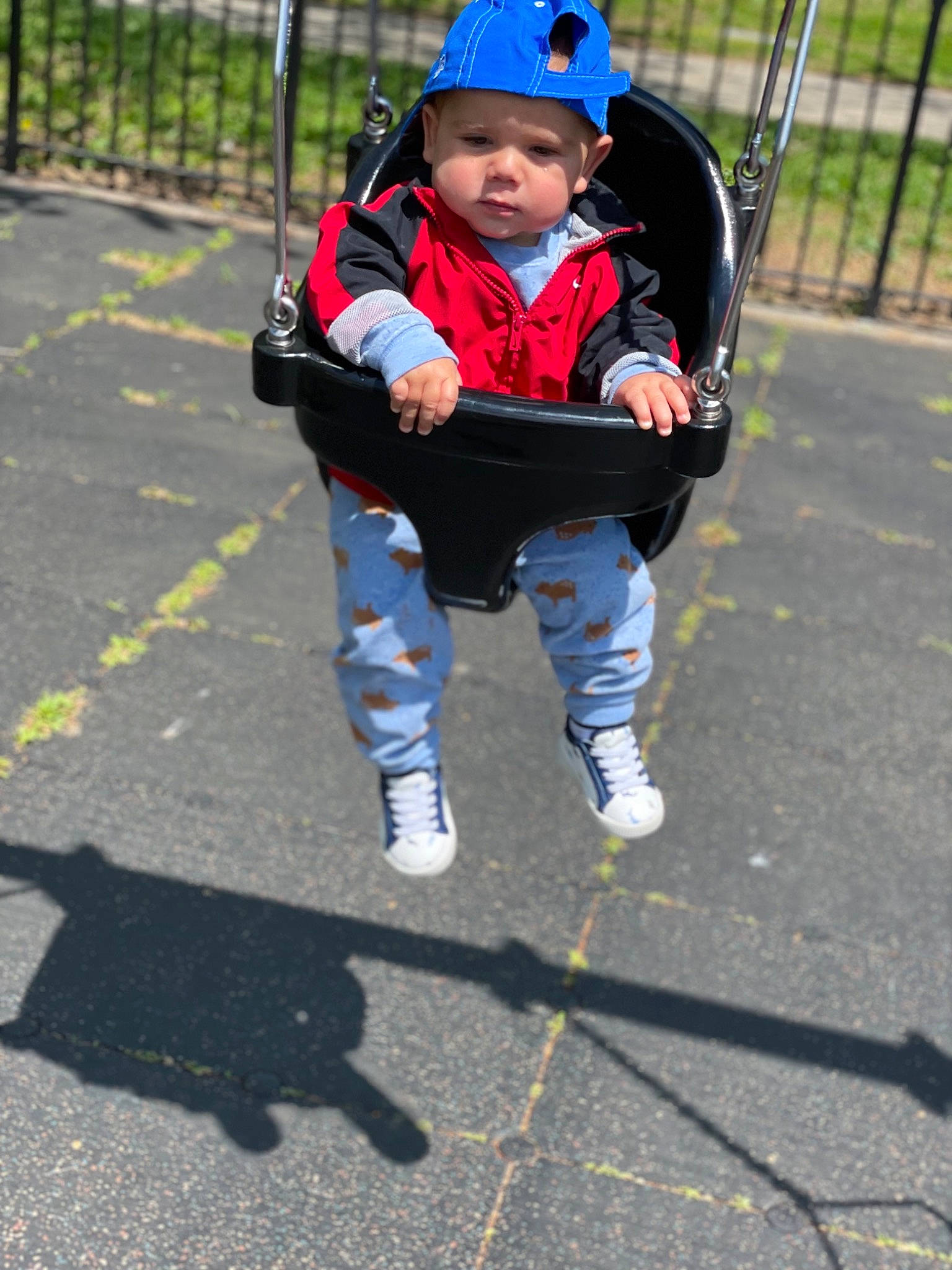 Jerry is registered to the contest to win money with this photo: asphalt, baby, carmine, child, city, electric_blue, eye, fence, fun, grass, headwear, leisure, person, personal_protective_equipment, recreation, road, road_surface, shadow, sidewalk, sports_gear