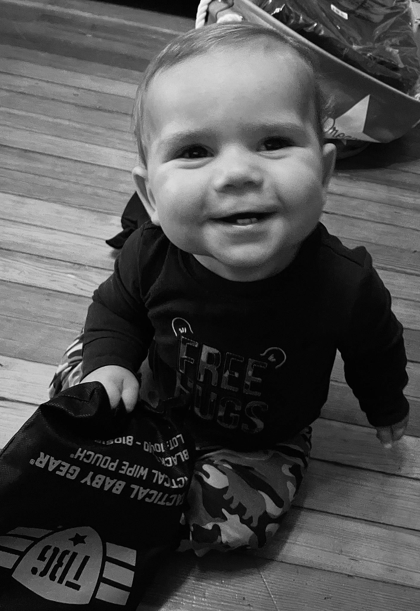 Jerry is registered to the contest to win money with this photo: baby, baby_toddler_clothing, black, black_and_white, child, cool, facial_expression, flash_photography, hairstyle, happy, human, iris, joy, person, photograph, skin, sleeve, smile, standing, style