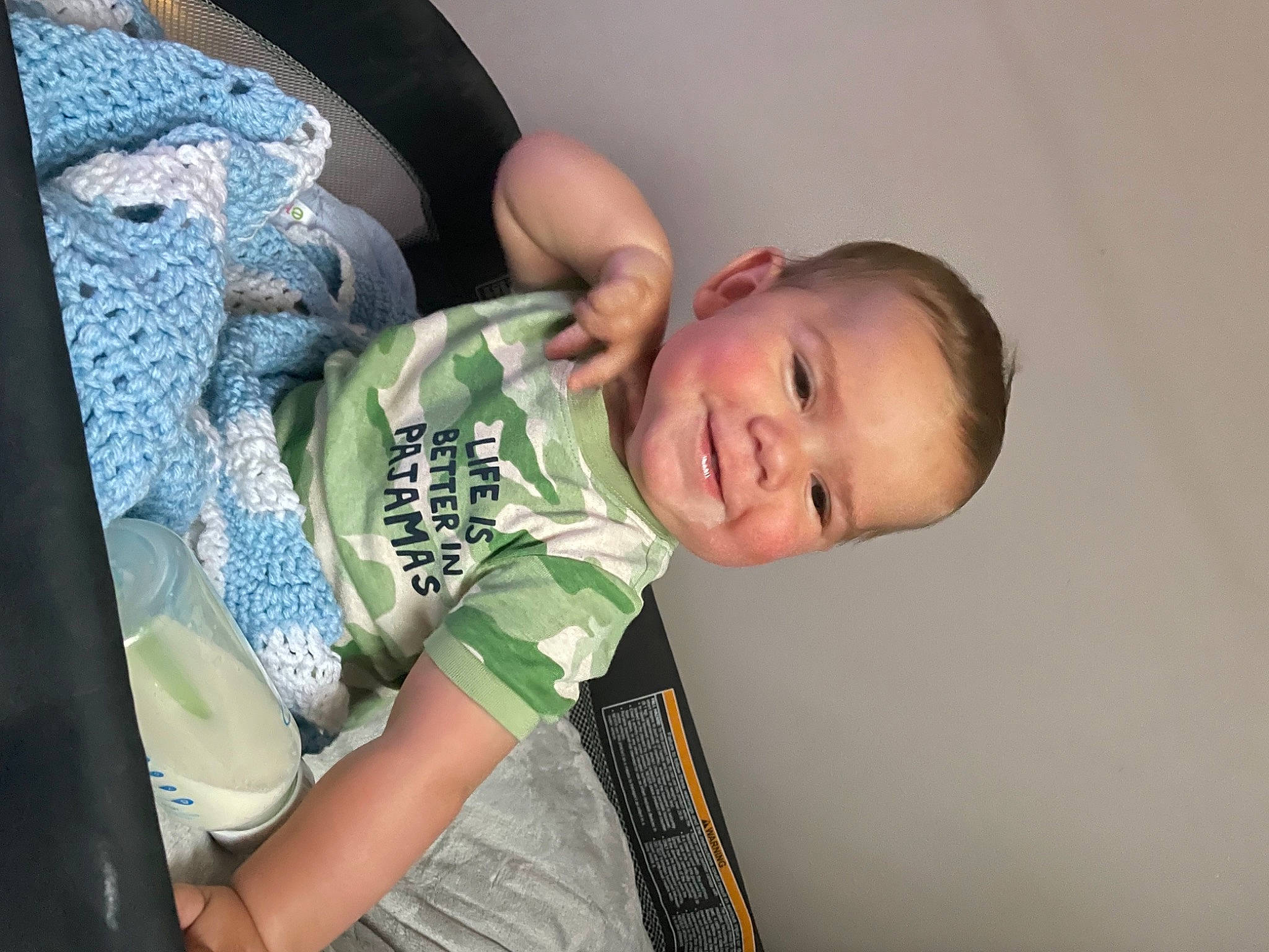 Jerry is registered to the contest to win money with this photo: arm, baby, baby_toddler_clothing, cheek, child, comfort, elbow, finger, fun, happy, human_leg, joy, leg, person, room, sitting, sleeve, t_shirt, thigh, toddler
