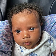 Beautiful joined the competition — help win amazing prizes! baby, infant, child, curly_hair, blue_eyes, close_up, portrait, cute, clothing, white_shirt, butterfly_pattern, fabric, multicolored, soft_texture, person, young_child, human, face, head, skin